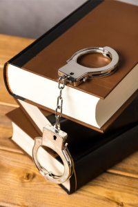 A book with handcuffs on top.